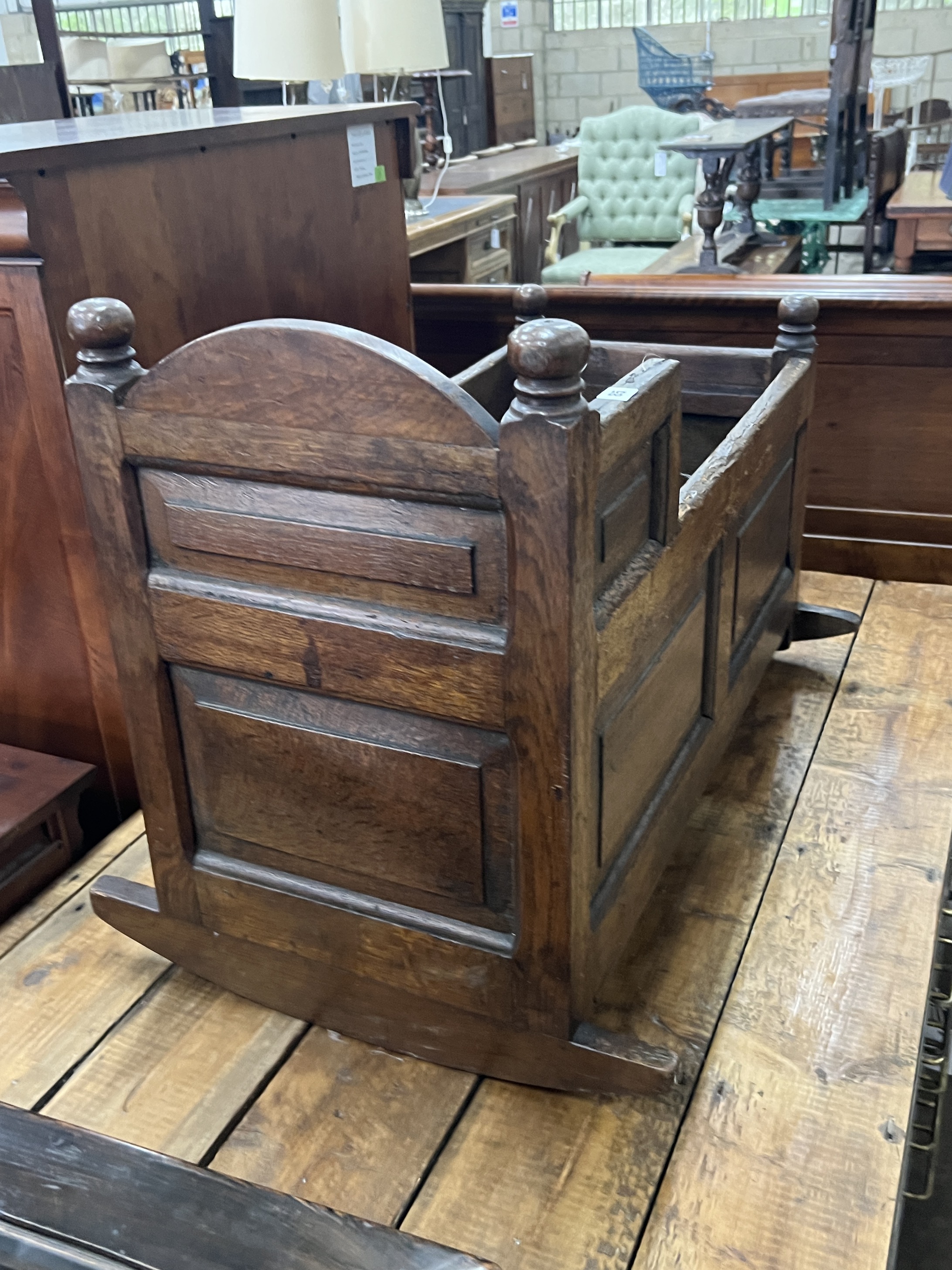An 18th century panelled pine rocking crib, length 89cm, width 59cm, height 63cm